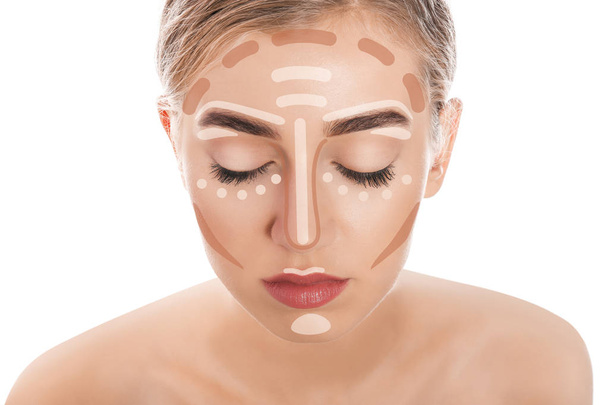 Beautiful young woman with different color foundations on face against white background. Makeup contouring - Photo, Image