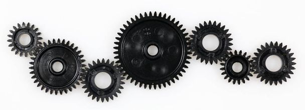 Several gears that are in connection with each other on a white background - Фото, изображение