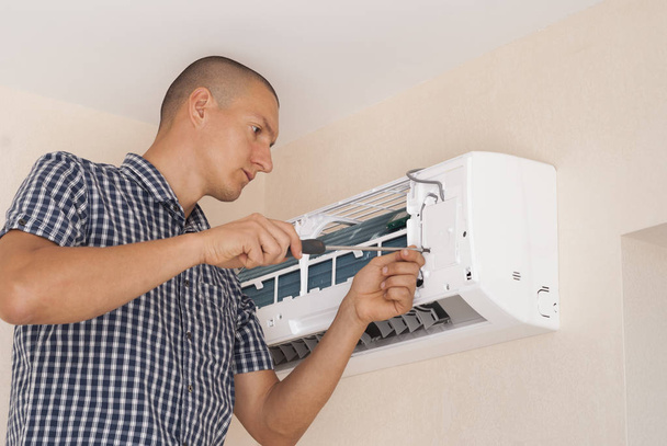 worker installs the indoor unit air conditioner on the wall - Photo, Image