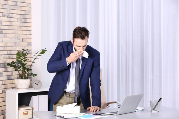 Ill businessman suffering from cough in office - Photo, Image