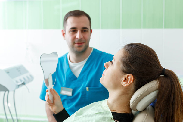 Mature male dentist working with woman patient visiting with a mirror dentist having dental checkup at the clinic dentistry occupation treatment medical industry healthcare people insurance - Foto, immagini