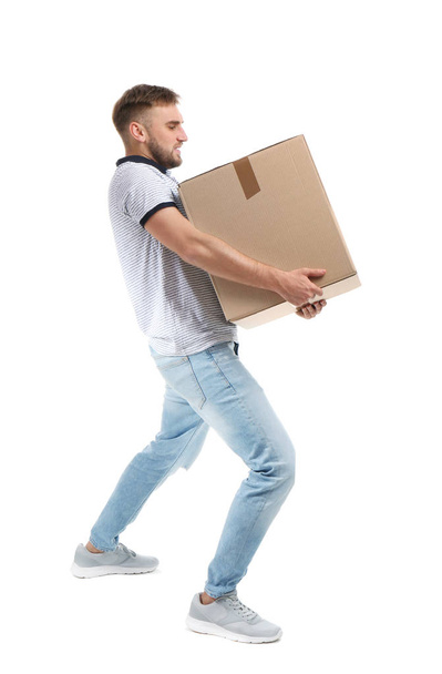 Full length portrait of young man carrying carton box on white background. Posture concept - Zdjęcie, obraz