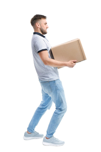 Full length portrait of young man carrying carton box on white background. Posture concept - Fotó, kép
