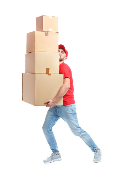 Full length portrait of man in uniform carrying boxes on white background. Posture concept - Foto, afbeelding