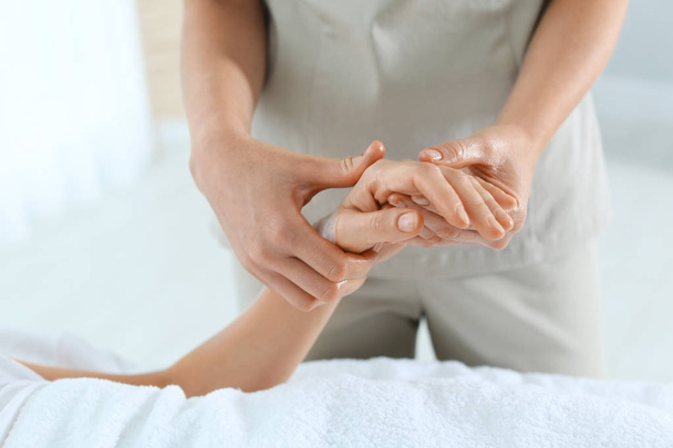 Woman receiving hand massage in wellness center, closeup - Photo, Image