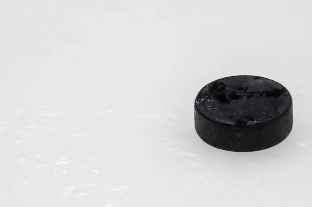 black hockey puck on ice rink. Winter sport. - Valokuva, kuva