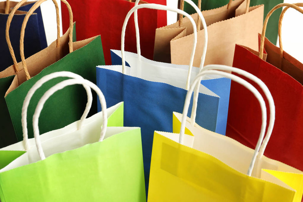 Colorful paper shopping bags as background, closeup - Фото, изображение