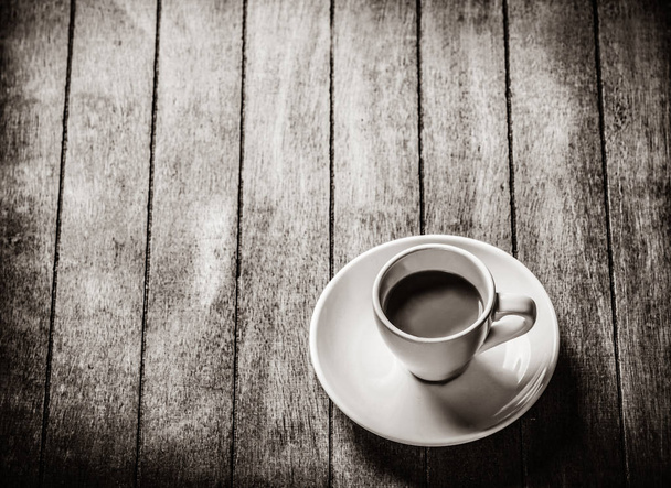 Little a cup of coffee on a wooden table. - Foto, Imagen