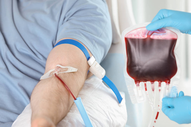 Man donating blood to save someone's life in hospital - Photo, Image