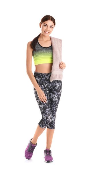 Beautiful young woman in sportswear with towel on white background - Foto, immagini