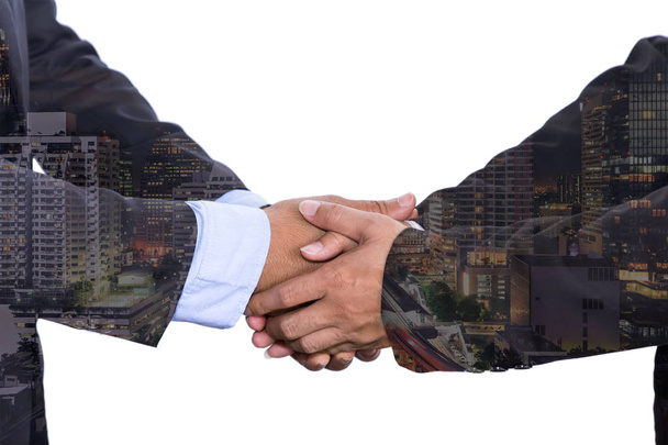 Double exposure business people shake hand in meeting Asian style on city night background - Photo, Image
