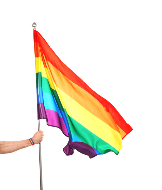 Gay man holding rainbow LGBT flag on white background - Photo, image