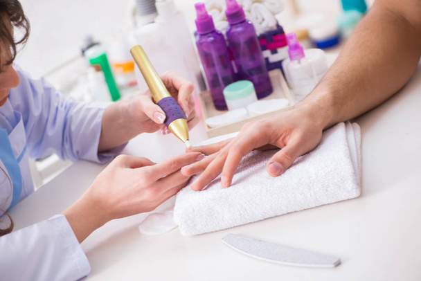 Hands during manicure care session - 写真・画像
