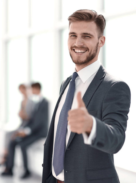 smiling businessman showing thumb up. - Фото, зображення