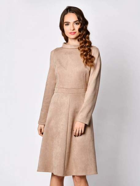 Young beautiful woman posing in new gray suede winter fashion dress  - 写真・画像