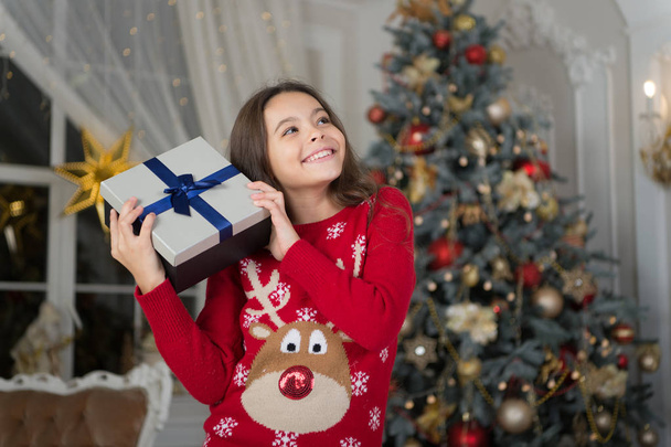 Christmas. Kid enjoy the holiday. The morning before Xmas. New year holiday. Happy new year. little child girl likes xmas present. small happy girl at christmas. Christmas composition - Photo, Image