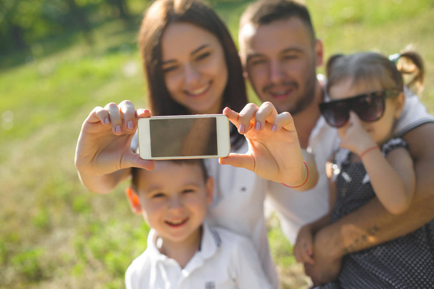 Cheerful family doing selfie outdoors - Foto, Imagem