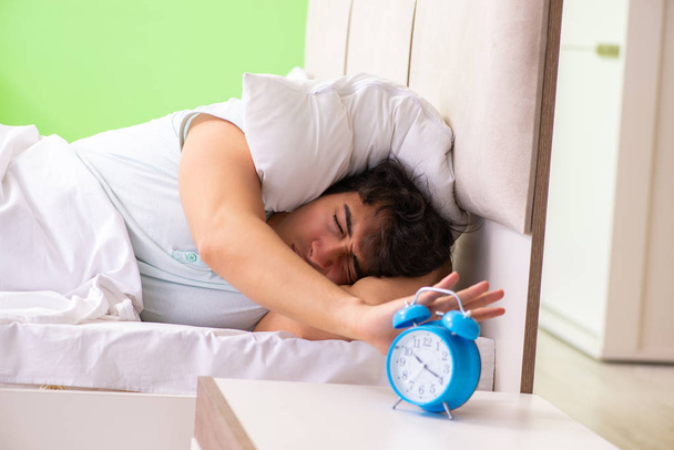 Young man having trouble waking up in early morning - Photo, Image