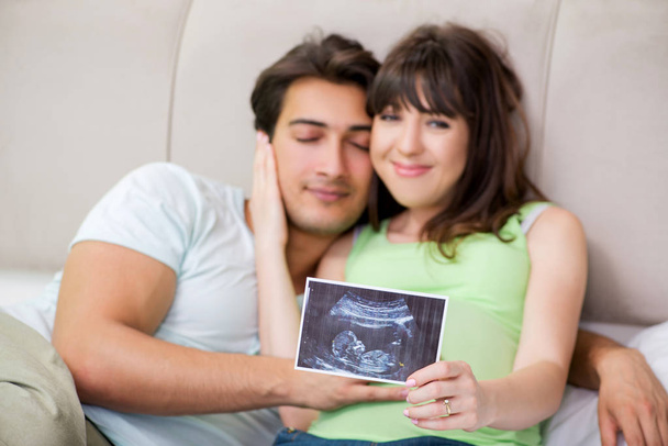 Young family finding out about pregnancy - Φωτογραφία, εικόνα