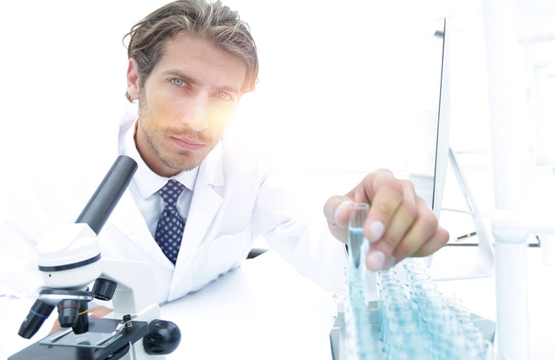 laboratory scientist working in a laboratory with a microscope - Фото, изображение