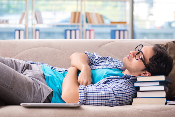 Tired student lying on the sofa  - 写真・画像