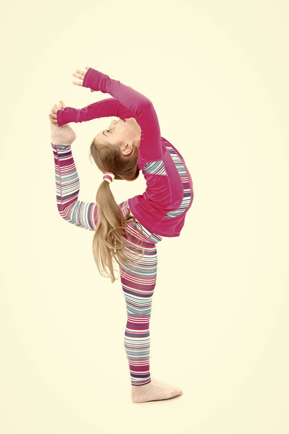 Workout of small girl isolated on white background. - 写真・画像