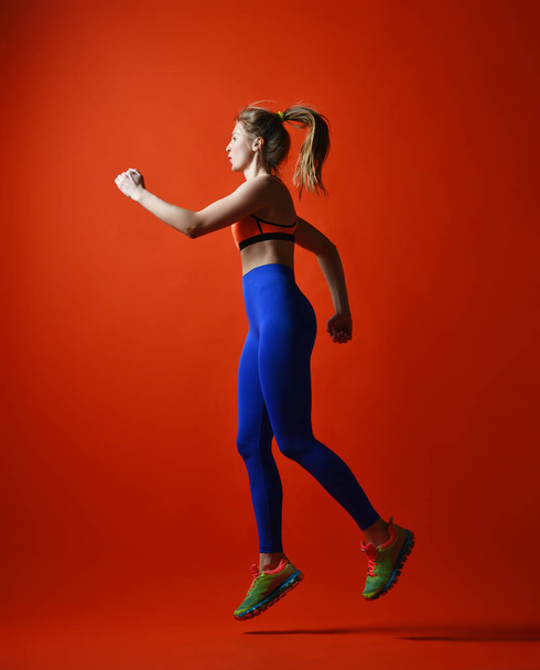 Attractive fitness girl in sportwear jumping - Фото, зображення