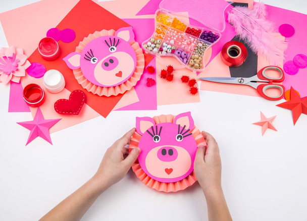 Children's master class hand-made paper pig. Decorative materials for creativity. Origami. Kindergarten and school. - Photo, Image