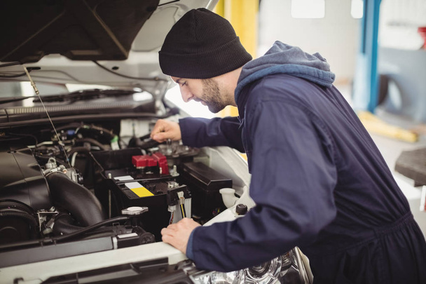 Mechanic servicing car at repair garage - Photo, Image