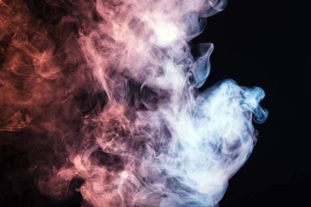 Colored smoke on a black background. The concept of a light show at a music concert - Photo, Image