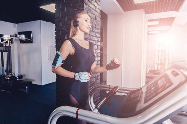 Happy women jogging on a treadmill for health. - Фото, зображення