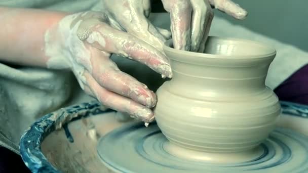 Woman girl her hands dub wall jug, sculpts out of clay on circle. - Footage, Video