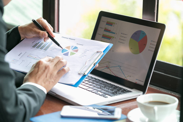  Два бізнесмени аналізують статистику фінансових даних на ноутбуці ПК, вказуючи на екран зі зростаючим графіком і графіками, обговорюючи зростання компанії
,  - Фото, зображення