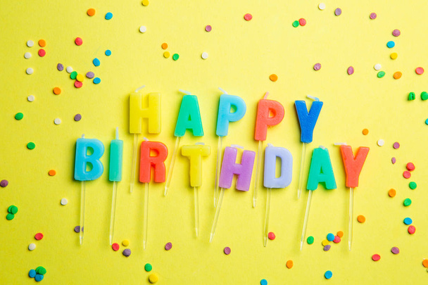 Birthday concept - candles with letters happy birthday and confetti - Foto, Imagem