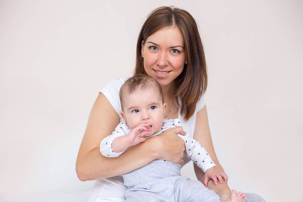 young mother is holding her newborn baby - Valokuva, kuva
