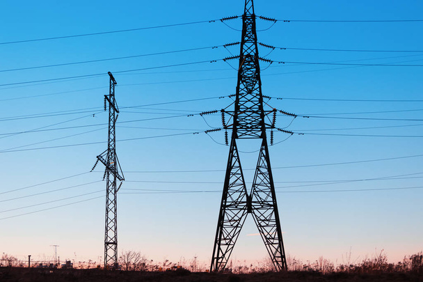 High-voltage power lines at sunset. Electricity distribution sta - Foto, Imagem