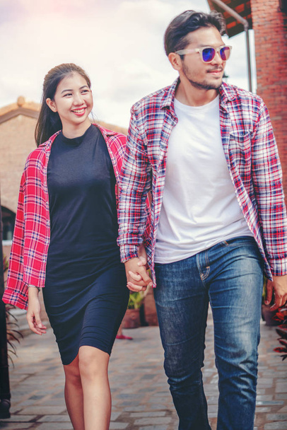 Happy young couple walking on the street in old town. Travel and dating concept. - Photo, Image