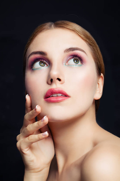 Perfect woman face closeup. Fashion girl with makeup on black background - Zdjęcie, obraz