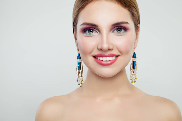 Glamorous woman fashion portrait. Cute girl with colorful makeup and gold earrings - Photo, Image