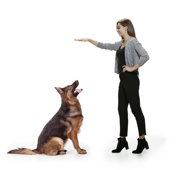 Woman with her dog over white background - Fotoğraf, Görsel