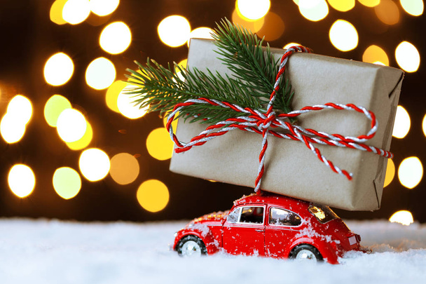 Red retro toy car delivering Christmas or New Year gifts - Foto, immagini