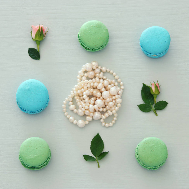 Top view of colorful macaron or macaroon over pastel blue background. Flat lay - Foto, Imagen