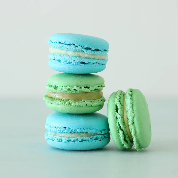 Image of romantic colorful macaron or macaroon over pastel background - Foto, Imagen
