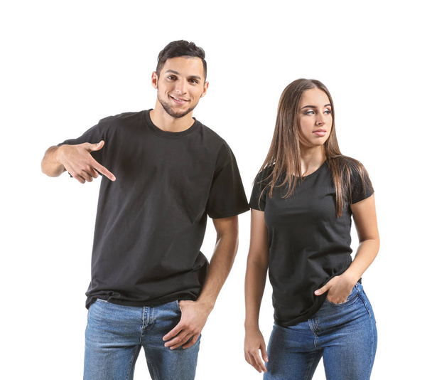 Fiatal férfi és nő a stílusos pólók-fehér háttér - Fotó, kép