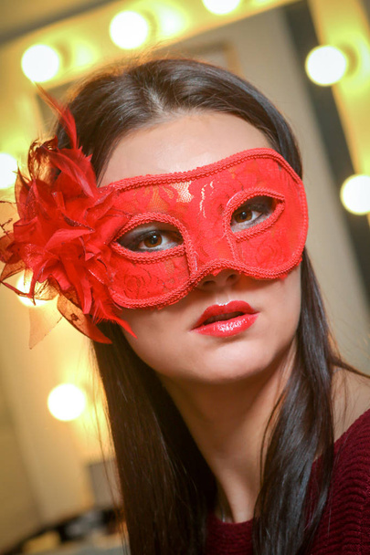 Closeup portrait of sexy woman in red, gold party mask for desire concept at New Year and Christmas party - Photo, Image