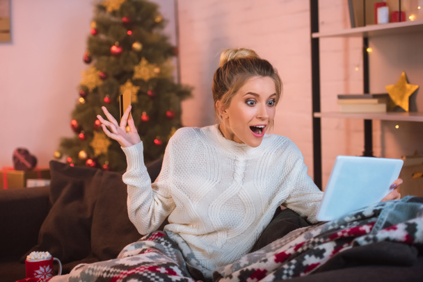 excited woman holding credit card and doing online shopping - Photo, Image