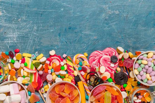 close up of Colorful Candies mixed on blue background  - Zdjęcie, obraz