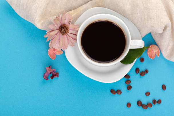 top view of Cup of coffee on a blue table - Foto, afbeelding