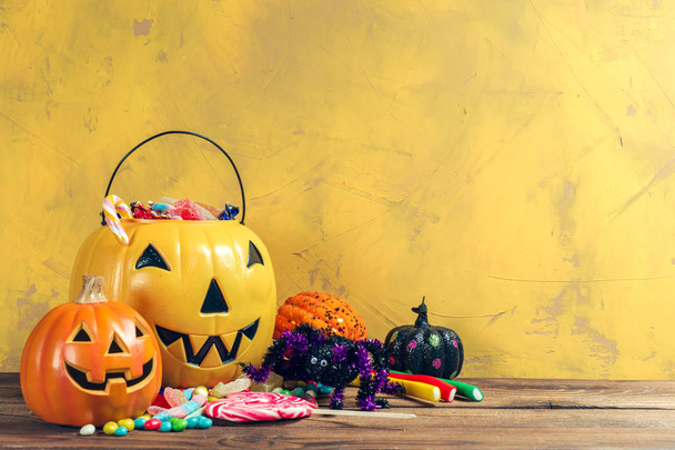 Happy halloween! Pumpkins with candies. Festive decorations and food. - Foto, afbeelding