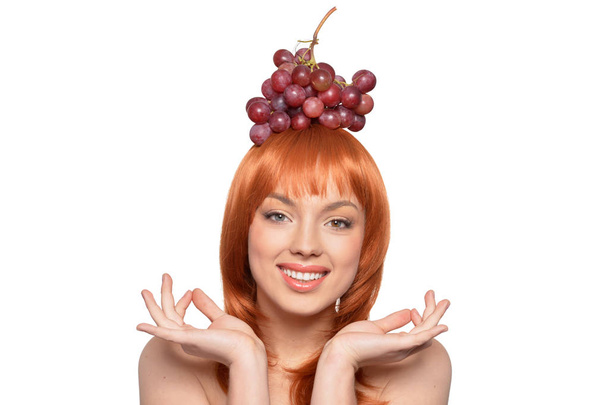 Portrait of a cute girl with red grapes - 写真・画像
